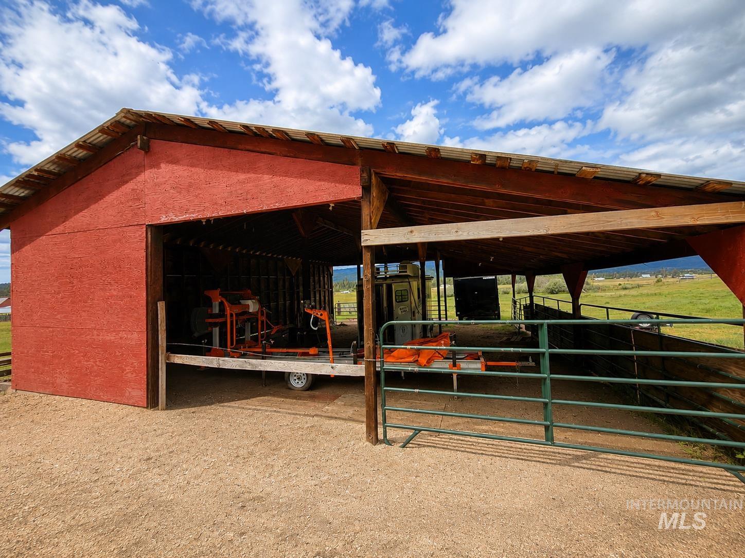 40 Atkin Lane Cascade, ID 83611 - Photo 23 of 46 Red barn structure featuring a metal roof and open-air covered areas