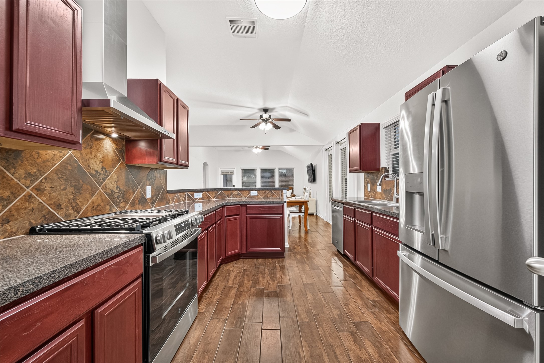 3155 View Valley Trail Katy, TX 77493 - Photo 20 of 50 Gourmet kitchen showcasing sleek stainless steel appliances, premium granite countertops, and rich cabinetry
