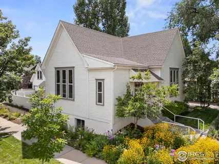 a aerial view of a house with a yard and potted plants