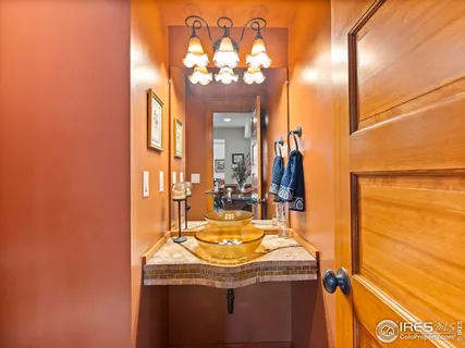 a dining room with furniture a chandelier and wooden floor
