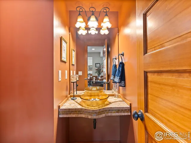 a dining room with furniture a chandelier and wooden floor
