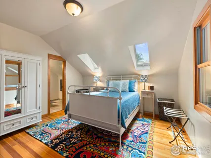 a bathroom with a granite countertop sink a large mirror and a shower