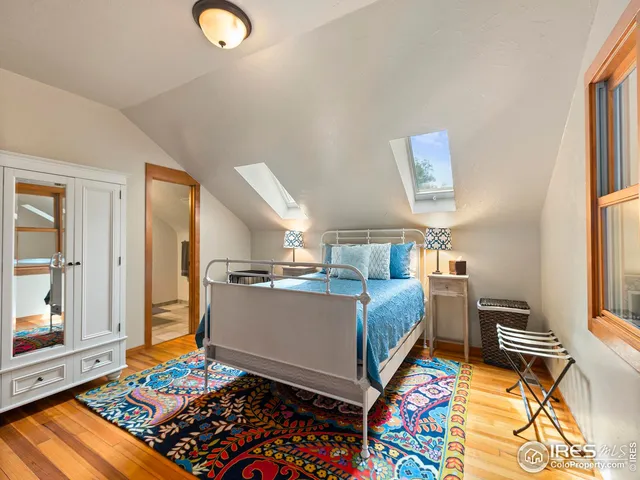 a bathroom with a granite countertop sink a large mirror and a shower