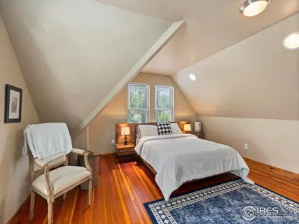 a bathroom with a granite countertop double vanity sink mirror and toilet