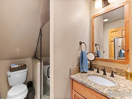 a view of a hallway with wooden floor and cabinets