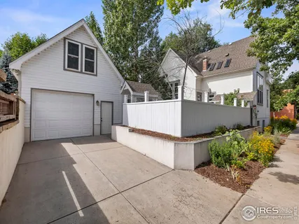 an aerial view of a house with balcony and garage