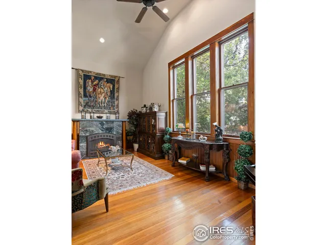 a living room with furniture and large windows