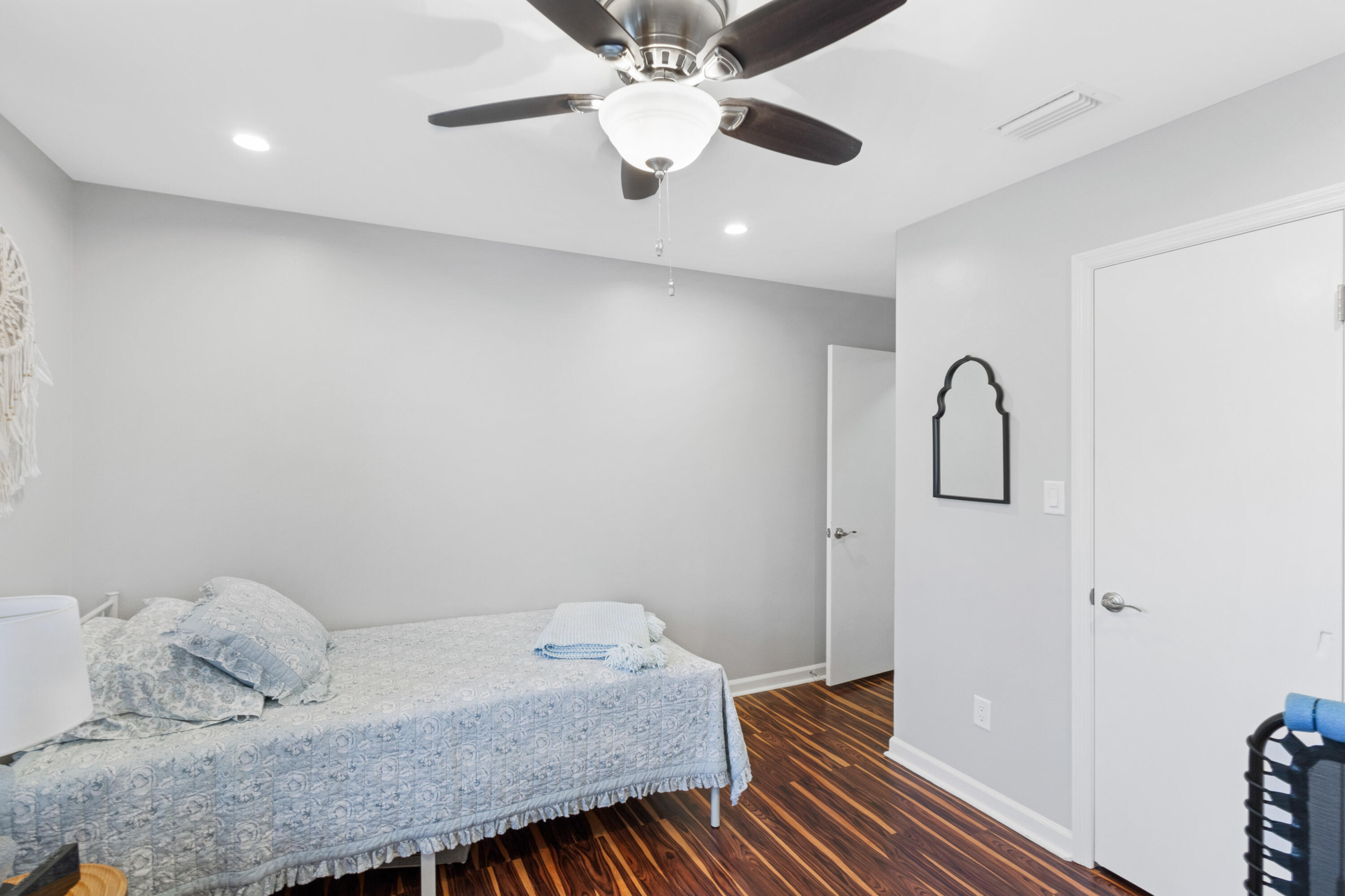 861 Mack Bayou Road Miramar Beach, FL 32550 - Photo 14 of 47 a bedroom with a bed and a chandelier