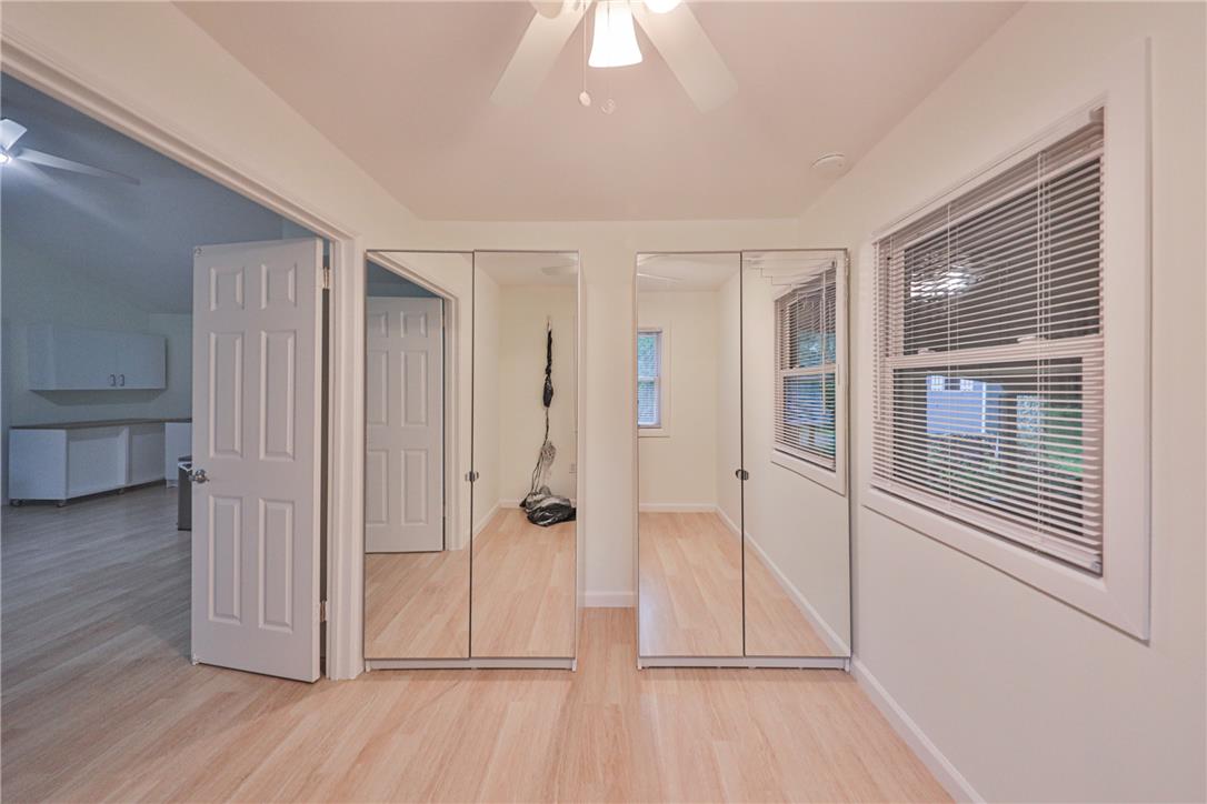 5599 Minks Pond Road Bushkill, PA 18324 - Photo 42 of 64 Blonde wood flooring and dual mirrored closets enhance this adaptable bedroom space.
