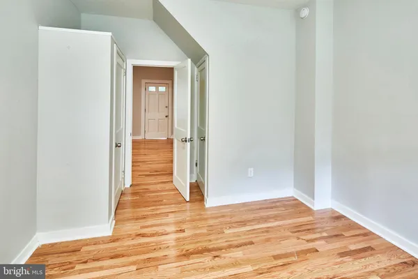 a view of a hallway with wooden floor and a hallway