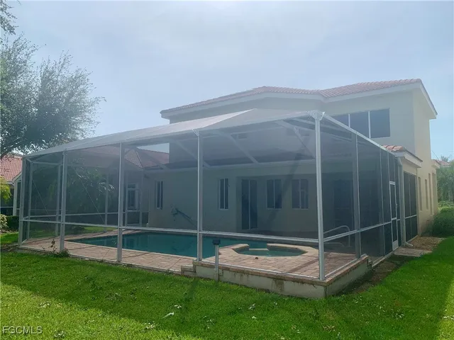 a view of a backyard with table and chairs and wooden fence