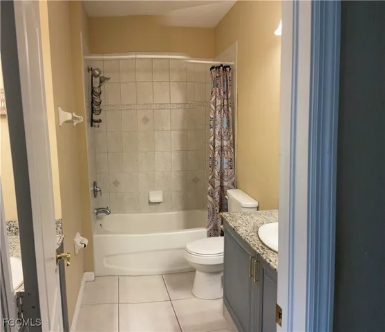 a bathroom with a granite countertop toilet a sink and a bathtub