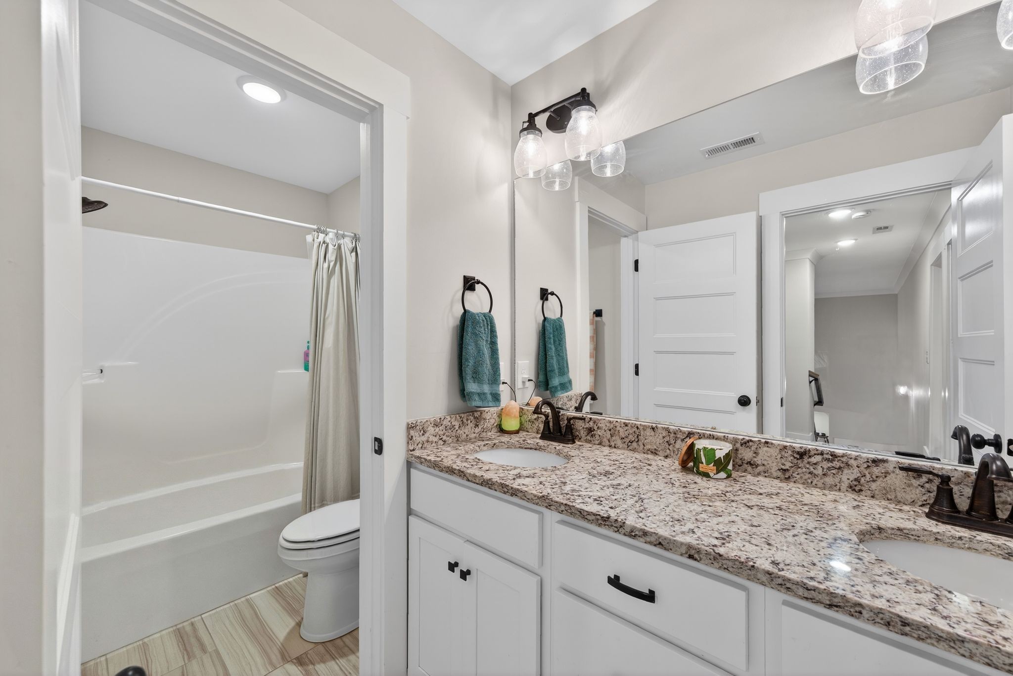 3834 Holly Grove Road Lascassas, TN 37085 - Photo 31 of 60 a bathroom with a granite countertop sink a toilet a mirror and shower