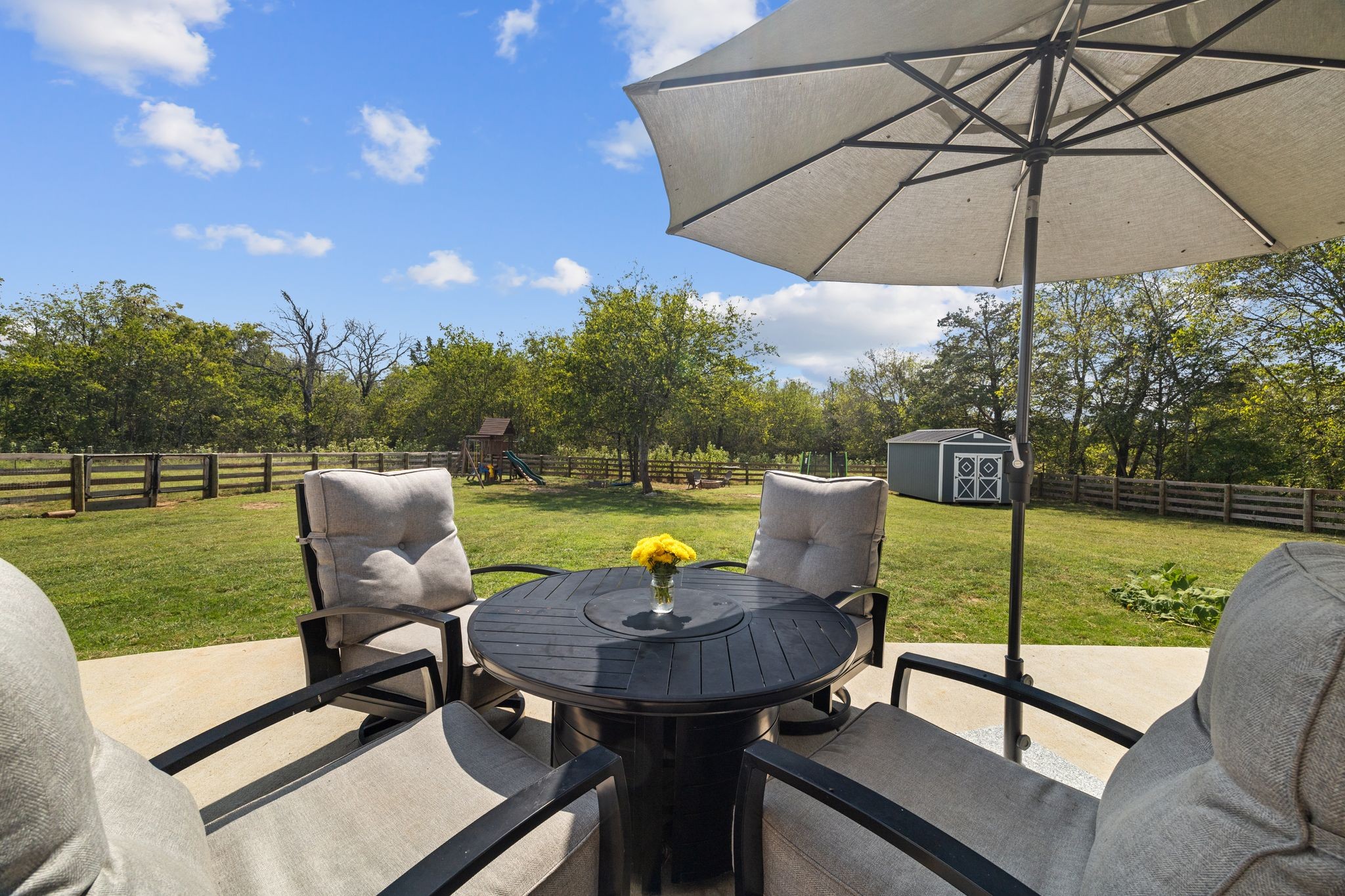 3834 Holly Grove Road Lascassas, TN 37085 - Photo 48 of 60 a view of a swimming pool with a table and chairs under an umbrella