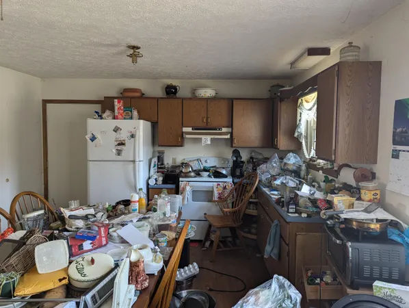a kitchen with a refrigerator and a stove top oven