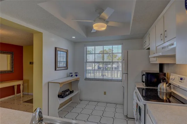 a kitchen with sink cabinets and stove