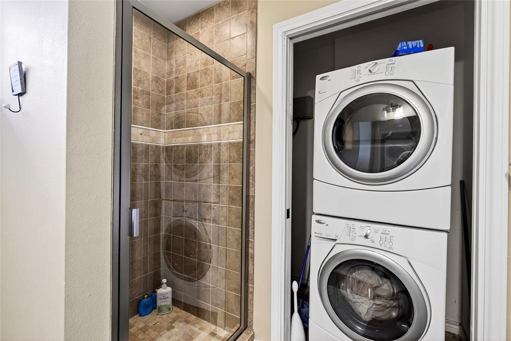 1113 Rim O The World Drive Tool, TX 75143 - Photo 24 of 40 Cabin full bathroom Shower enclosure with glass door and tile surround featuring an accent tile band and stackable washer and dryer.