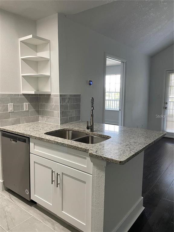 199 Afton Square, Unit 309 Altamonte Springs, FL 32714 - Photo 8 of 17 a kitchen with granite countertop stainless steel appliances a sink and cabinets