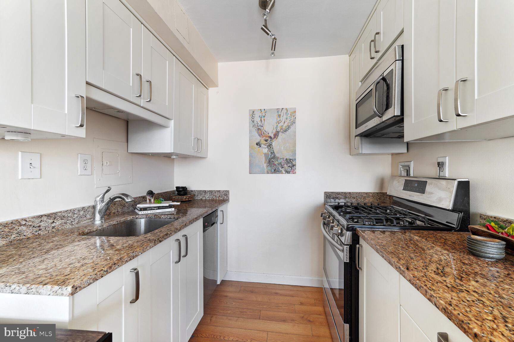 522 21st Street Northwest, Unit 903 Washington, DC 20037 - Photo 12 of 20 a kitchen with stainless steel appliances granite countertop a sink stove and cabinets