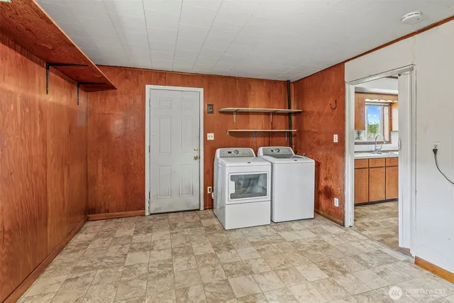 a view of a storage and utility room with washer and dryer