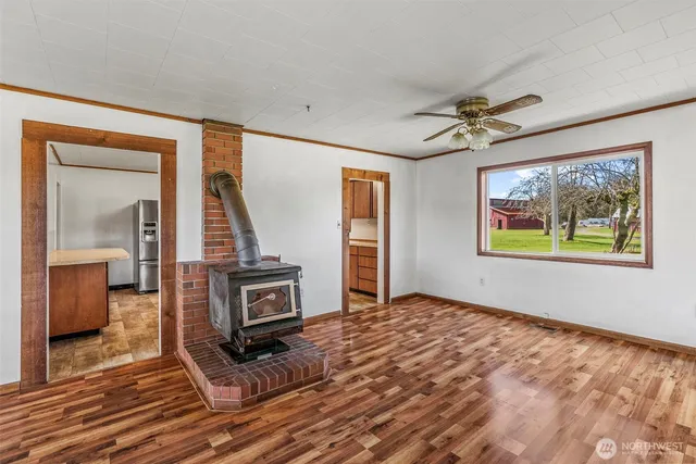 a view of a livingroom with wooden floor and a ceiling fan