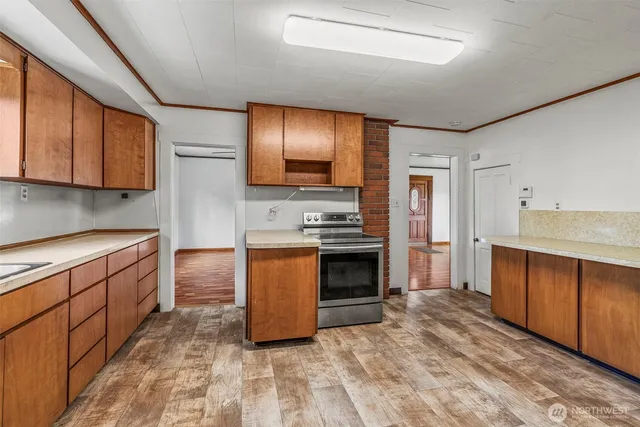 a kitchen with stainless steel appliances granite countertop a stove a sink and a refrigerator