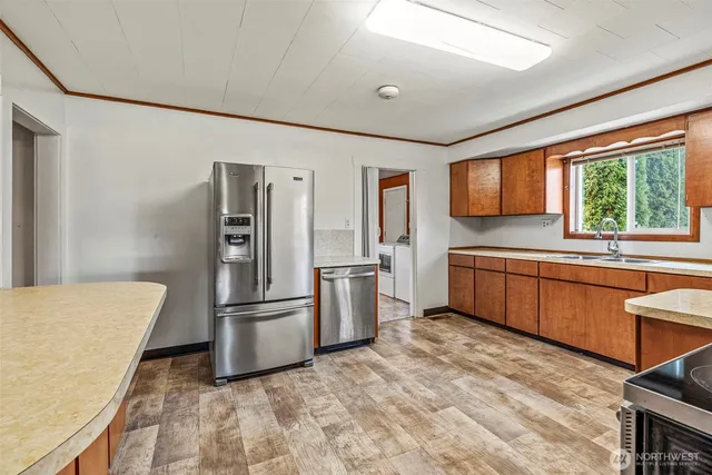 a kitchen with a refrigerator and a sink