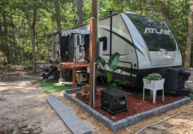 a view of house with a garden and sitting area