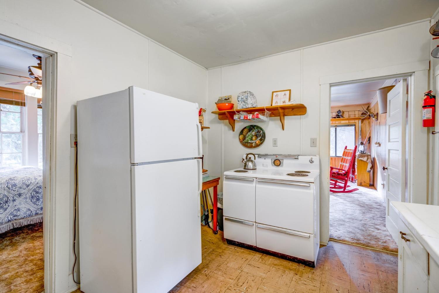 50062 Poplar Road Oakhurst, CA 93644 - Photo 17 of 38 a white refrigerator freezer sitting inside of a kitchen