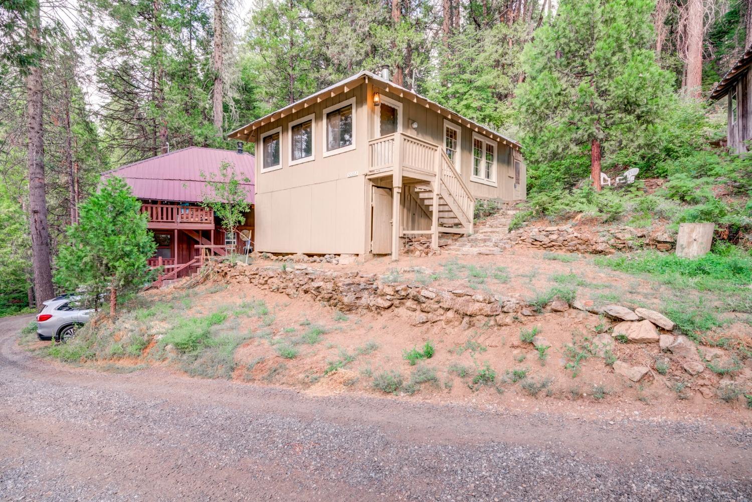 50062 Poplar Road Oakhurst, CA 93644 - Photo 2 of 38 a front view of a house with a yard and garage