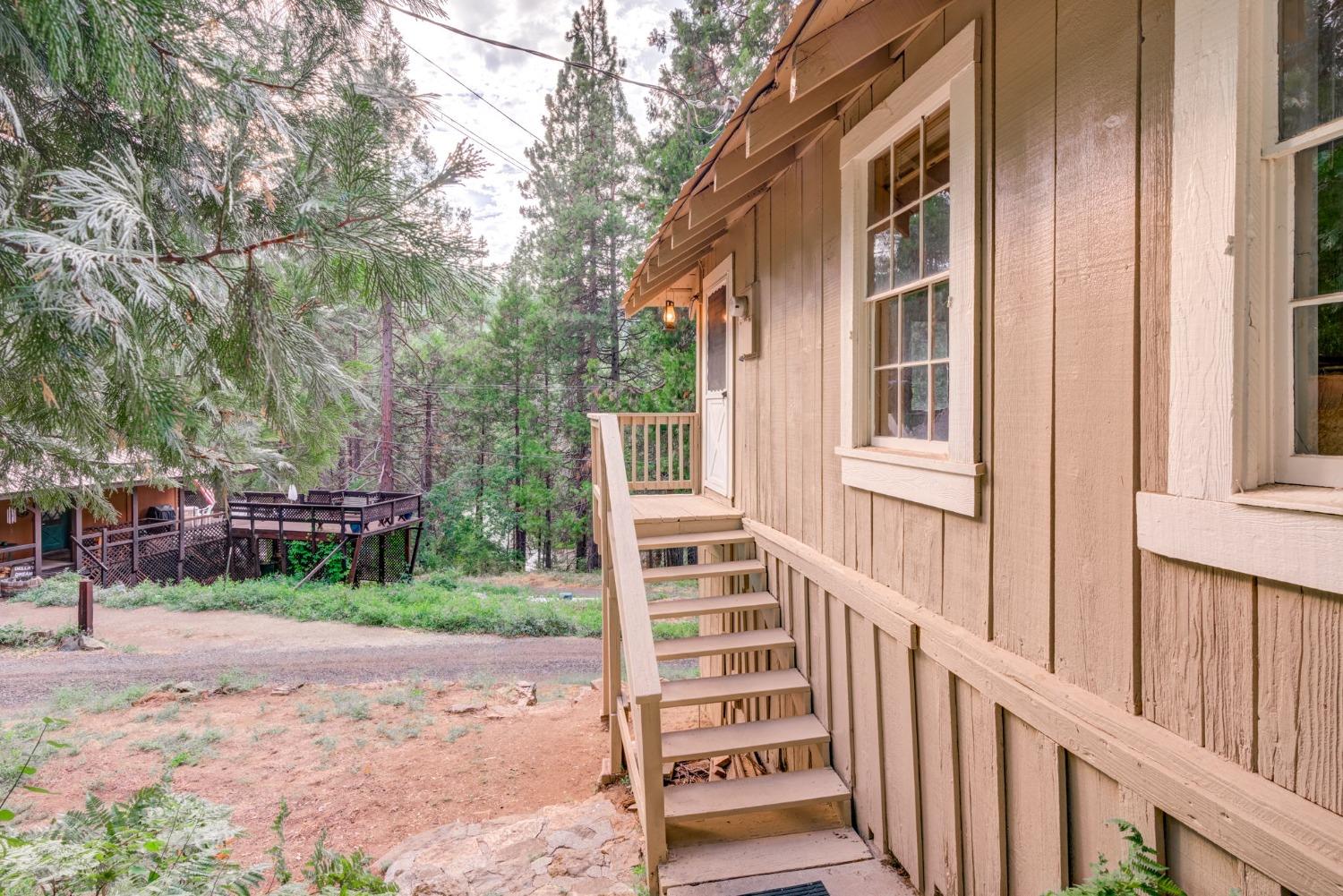 50062 Poplar Road Oakhurst, CA 93644 - Photo 28 of 38 a view of a house with a yard and large tree