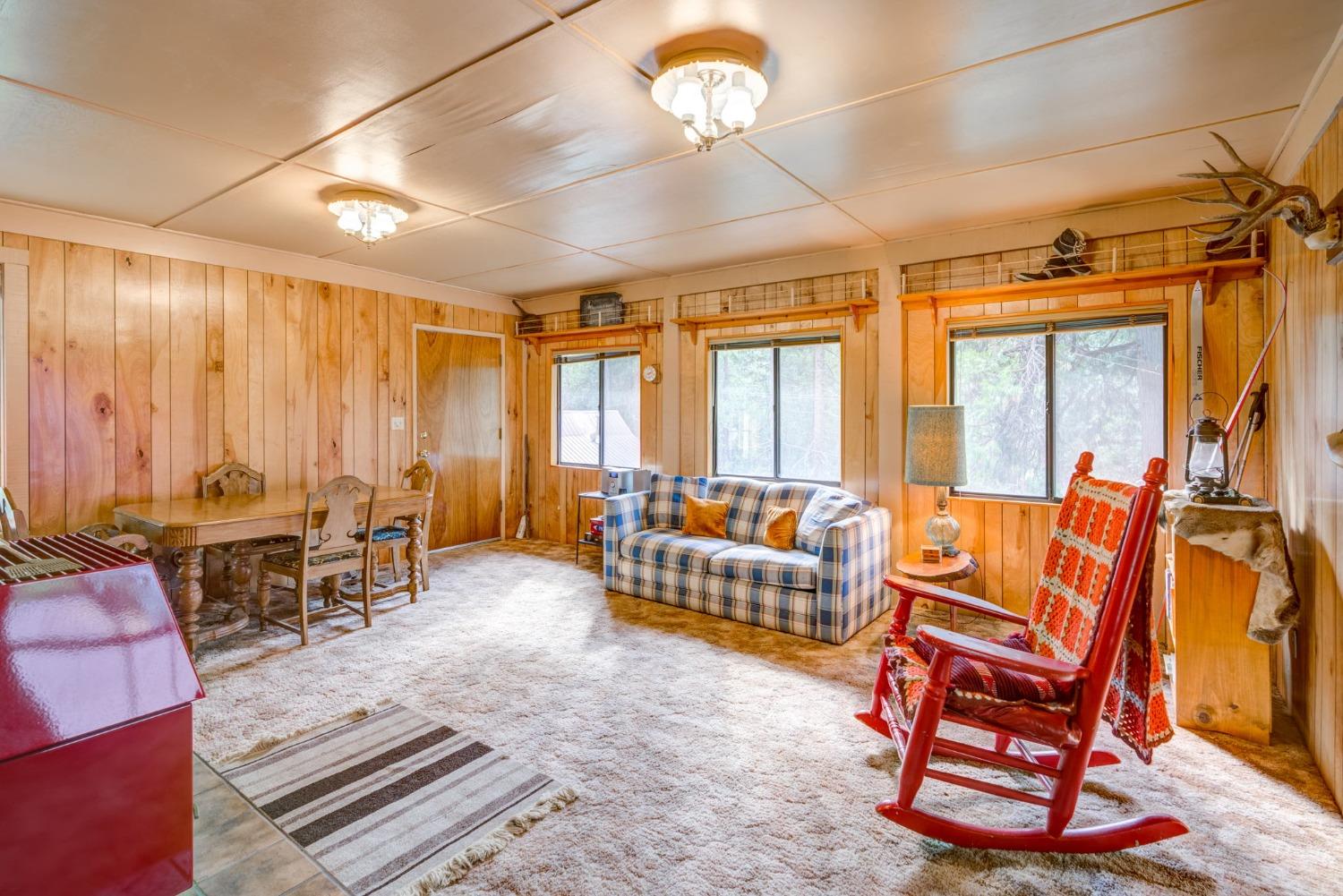 50062 Poplar Road Oakhurst, CA 93644 - Photo 6 of 38 a living room with furniture a large window and a chandelier