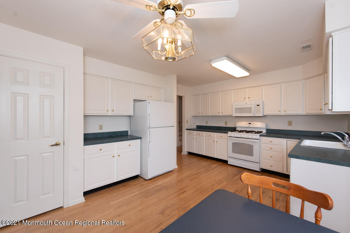 5 Dexter Lane Jackson, NJ 08527 - Photo 12 of 55 a kitchen with granite countertop white cabinets a stove a sink and dishwasher