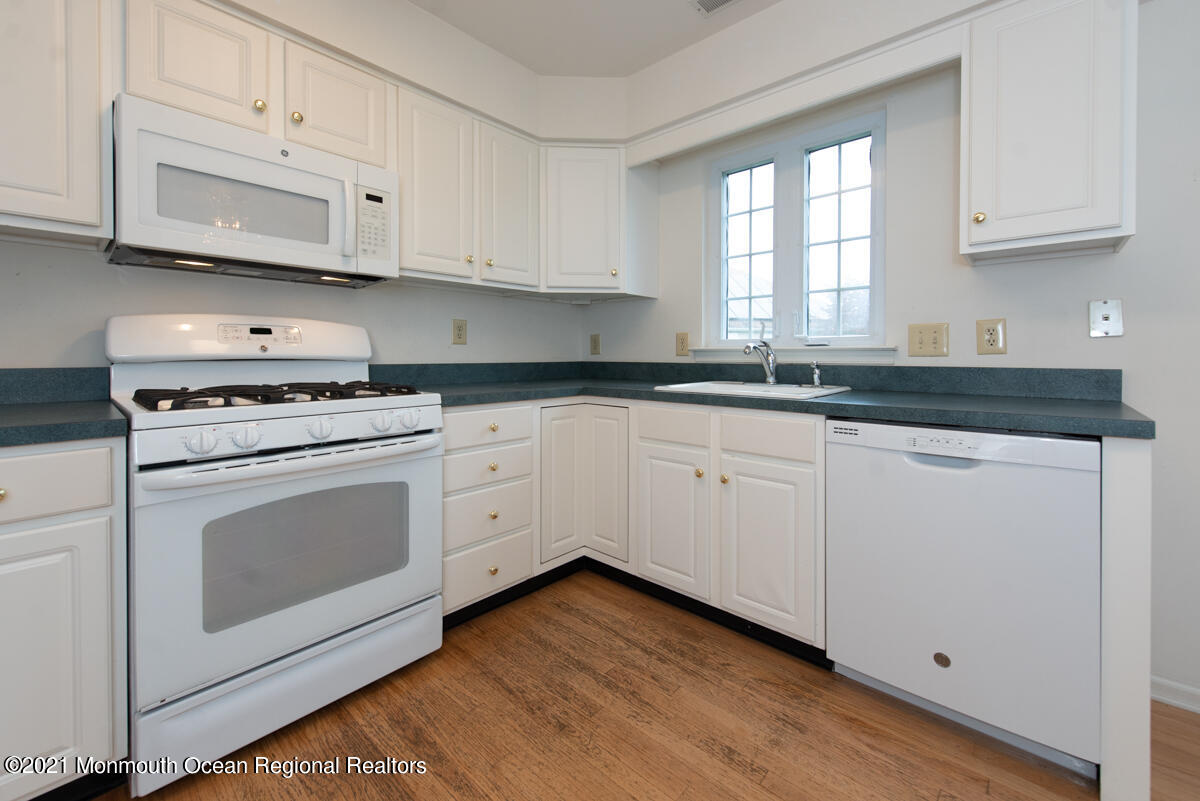 5 Dexter Lane Jackson, NJ 08527 - Photo 13 of 55 a kitchen with granite countertop white cabinets and white appliances