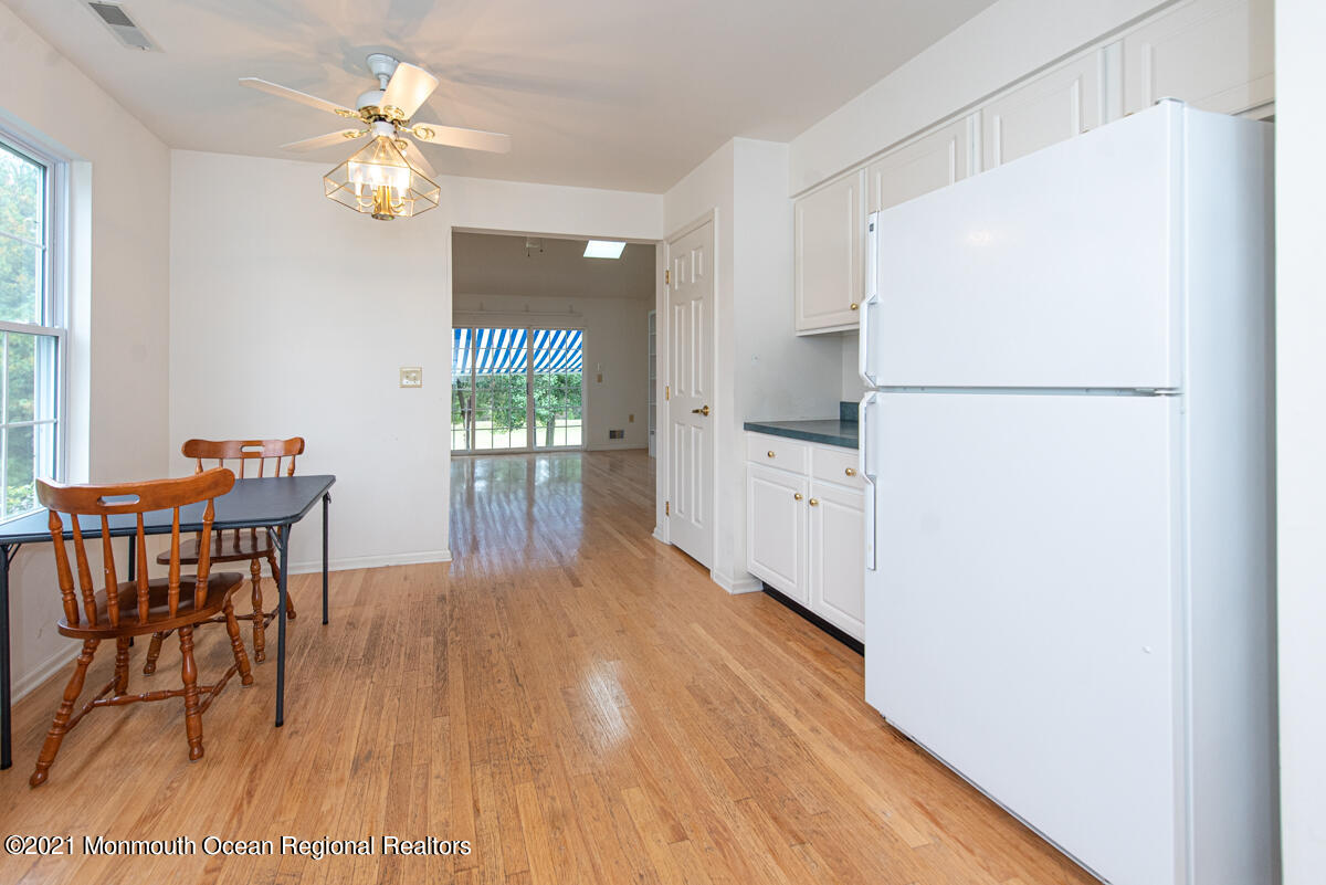 5 Dexter Lane Jackson, NJ 08527 - Photo 14 of 55 a kitchen with stainless steel appliances granite countertop a refrigerator a stove a dining table and chairs with wooden floor