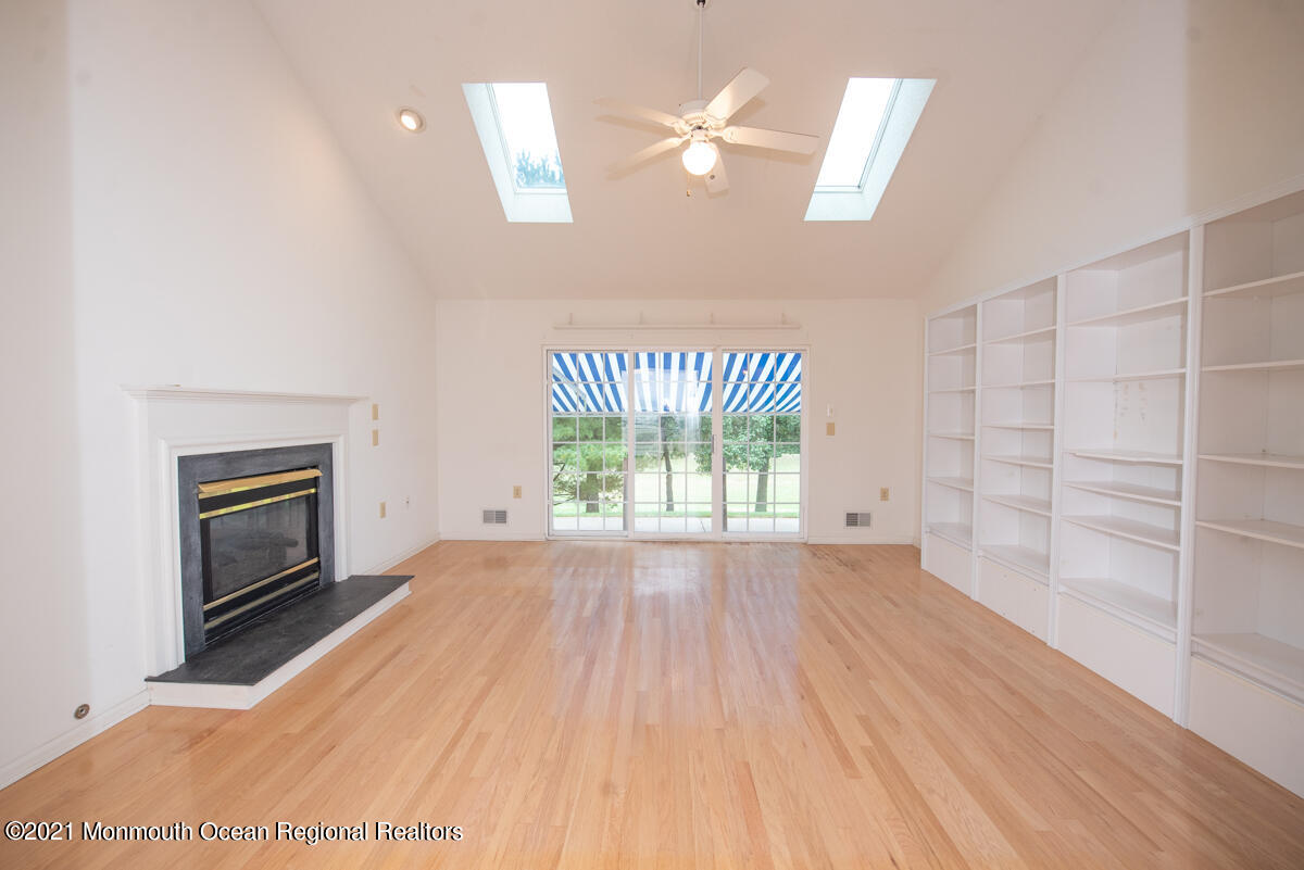 5 Dexter Lane Jackson, NJ 08527 - Photo 17 of 55 a view of an empty room with a window and wooden floor