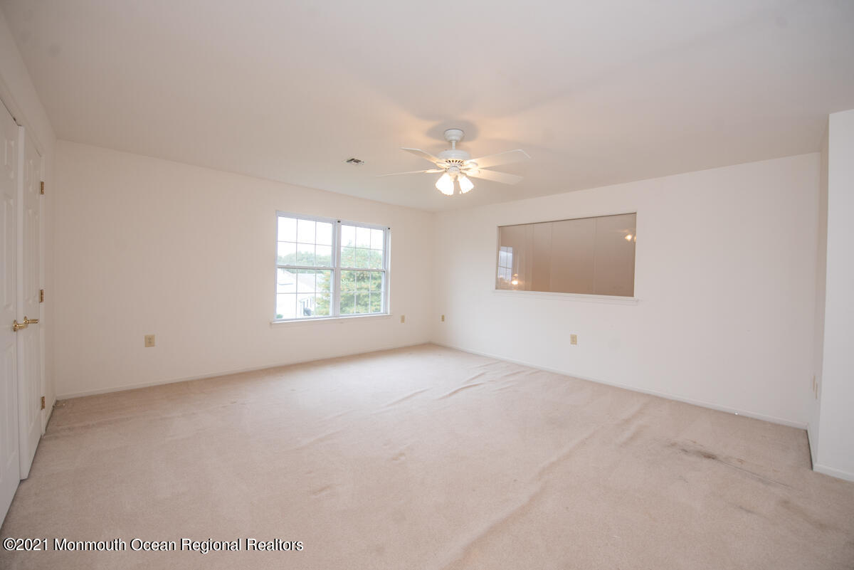 5 Dexter Lane Jackson, NJ 08527 - Photo 33 of 55 an empty room with chandelier fan and windows