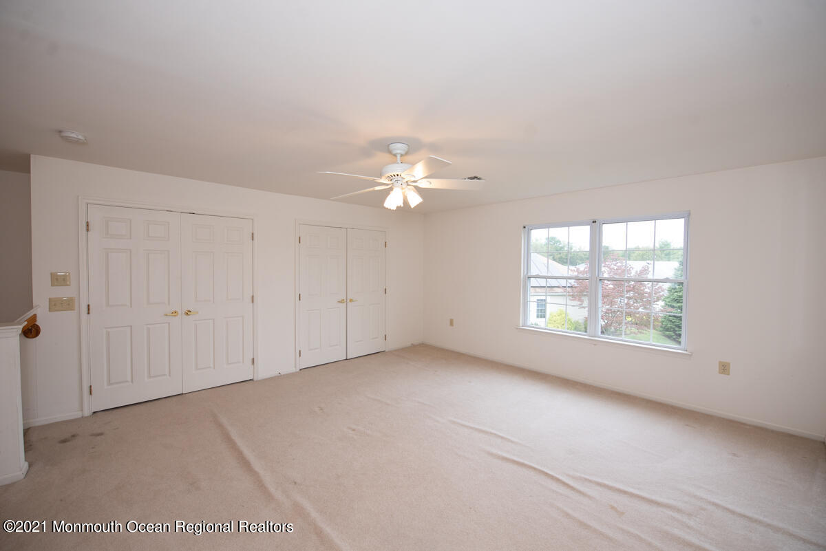 5 Dexter Lane Jackson, NJ 08527 - Photo 34 of 55 an empty room with windows and chandelier fan