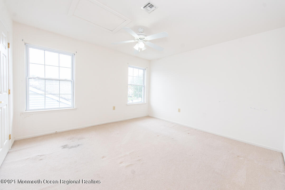 5 Dexter Lane Jackson, NJ 08527 - Photo 37 of 55 an empty room with windows and ceiling fan