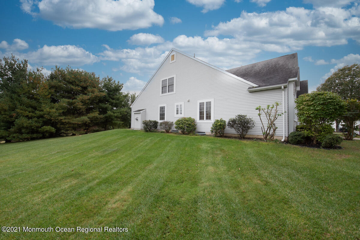 5 Dexter Lane Jackson, NJ 08527 - Photo 43 of 55 a view of a white house in front of a big yard with plants and large trees