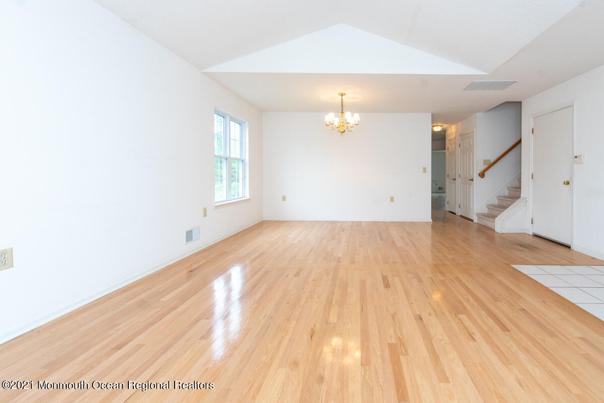 5 Dexter Lane Jackson, NJ 08527 - Photo 8 of 55 an empty room with wooden floor and chandelier fan