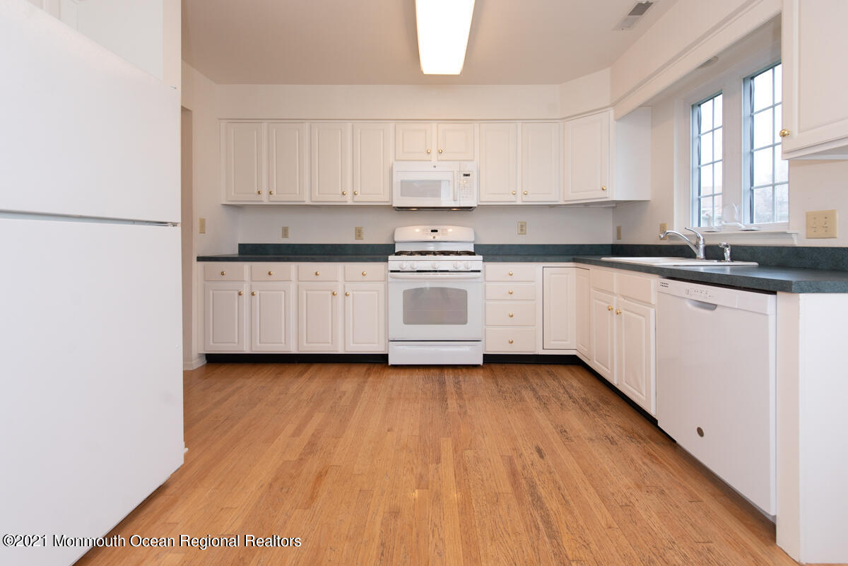 5 Dexter Lane Jackson, NJ 08527 - Photo 10 of 55 a kitchen with granite countertop white cabinets and white appliances