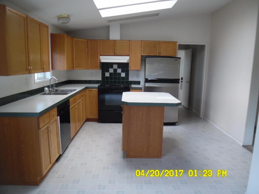 6519 Tolo Road Central Point, OR 97502 - Photo 4 of 5 a kitchen with a sink stove and cabinets