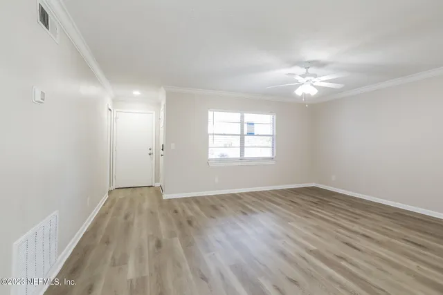 wooden floor in an empty room with a window