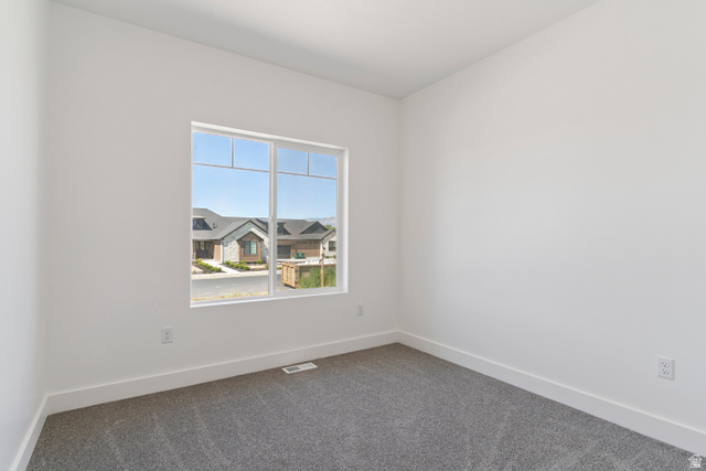 5777 West 4100 South Hooper, UT 84315 - Photo 22 of 41 Empty room featuring baseboards and dark carpet