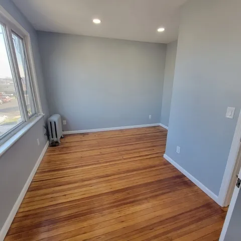 a view of a room with wooden floor and chair