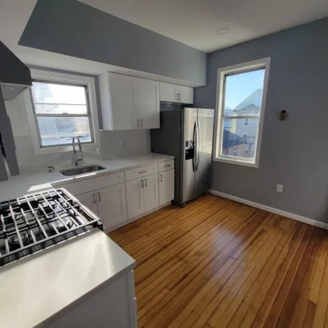 a kitchen with stainless steel appliances a sink dishwasher stove and refrigerator