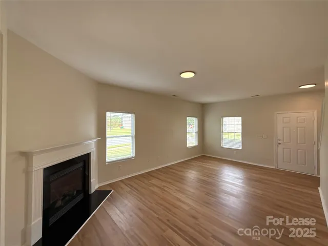 a view of empty room with window and fireplace