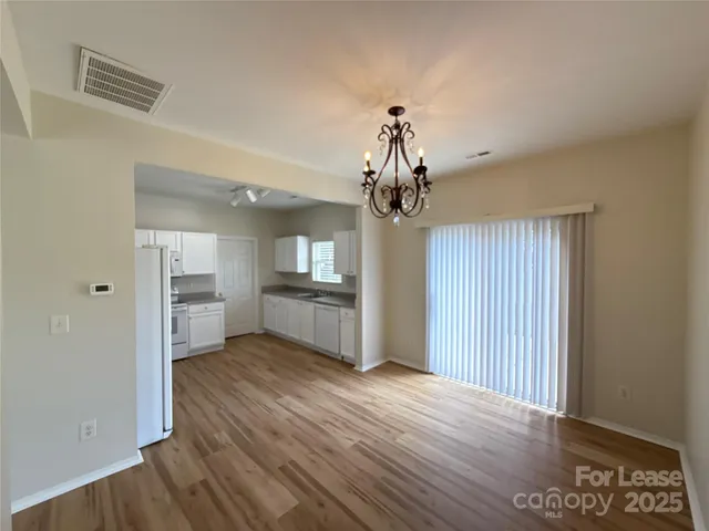 a view of a kitchen with a sink and wooden floor