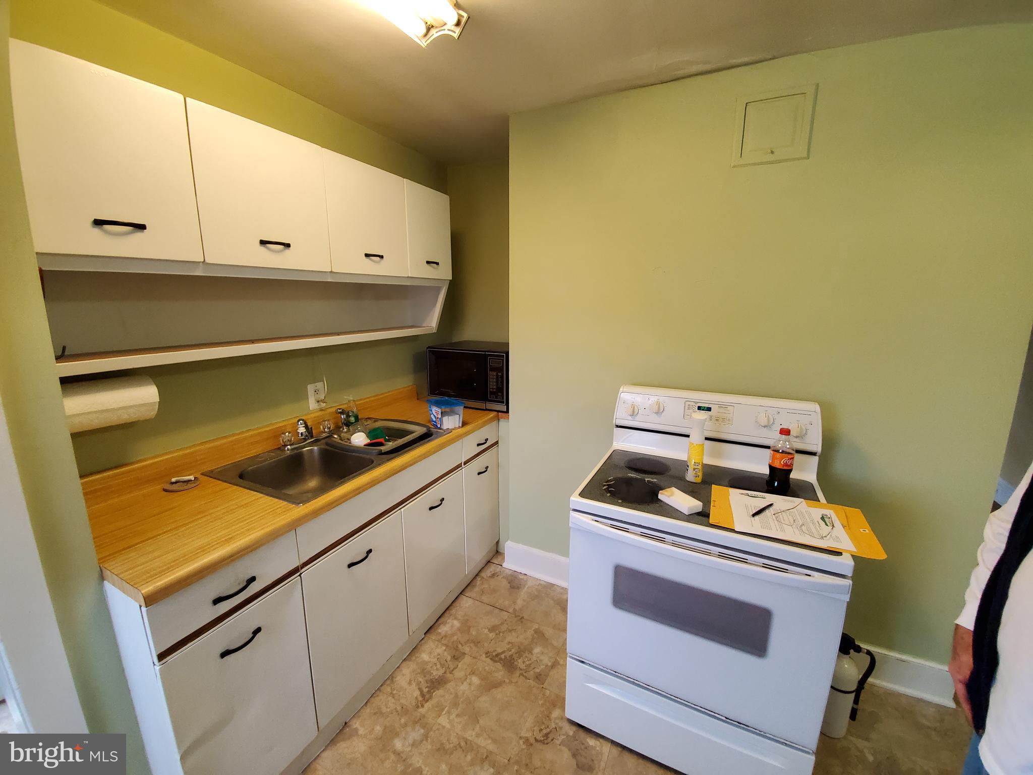 527 Old Meetze Road Warrenton, VA 20186 - Photo 10 of 10 a kitchen with a stove and white cabinets